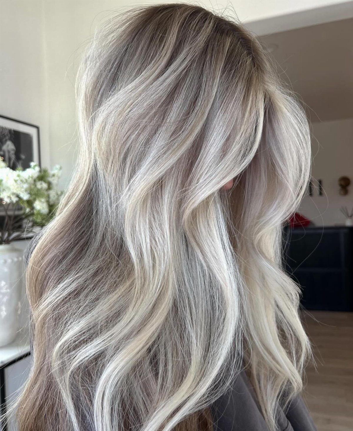 Long wavy ash-blonde hair with bright platinum highlights and darker roots