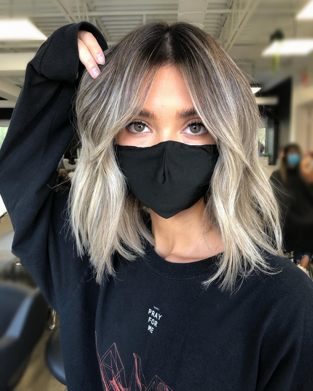 Ash blonde long bob with dark roots, center part, and softly layered ends