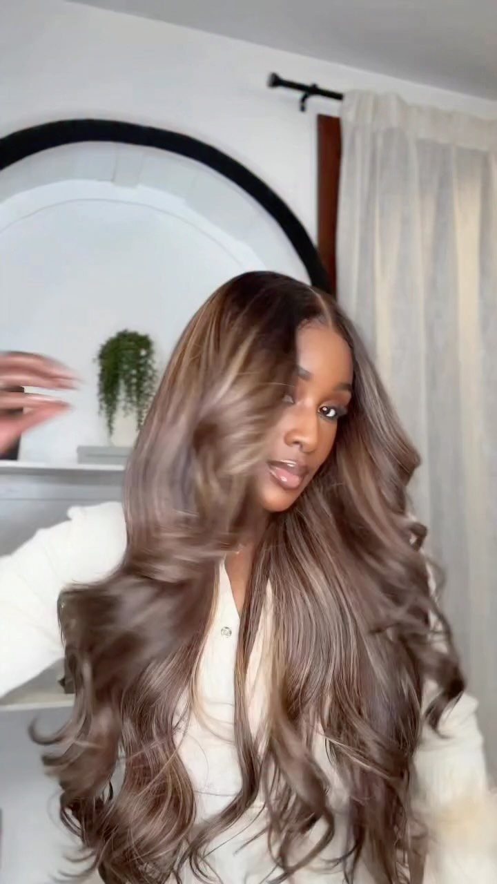 Woman showing long dark brown hair with subtle cool ash blonde highlights