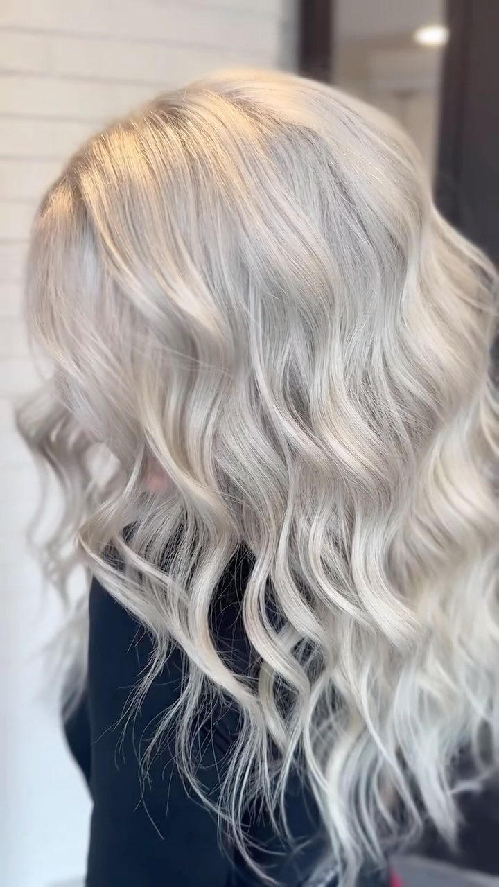 Long wavy platinum ash blonde hair with cool gray tones