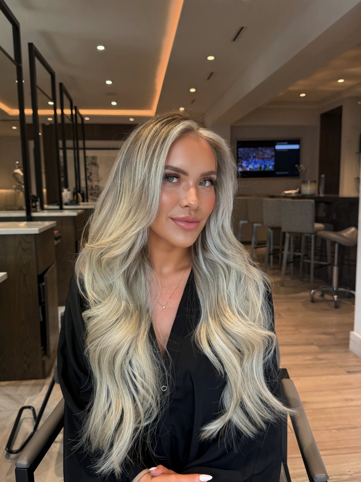 Woman with long dimensional beige platinum blonde hair in loose waves