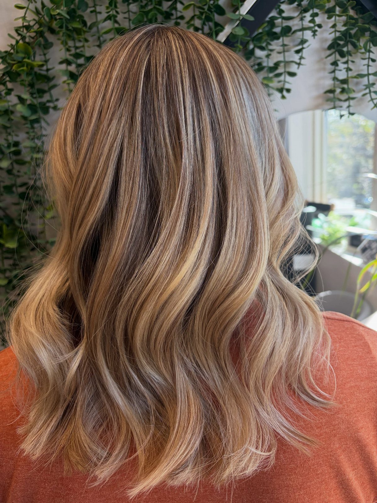 Long dark wavy hair with abundant beige blonde and silver highlights