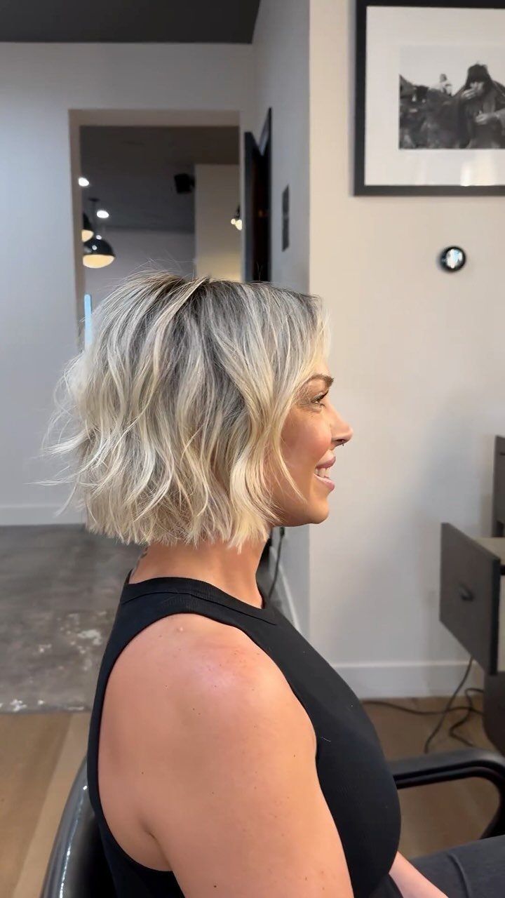 Blonde bob with loose waves and flipped ends shown in side profile