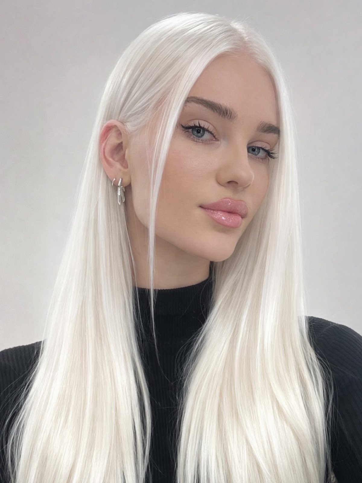Woman with long, straight platinum-blonde hair and a center part