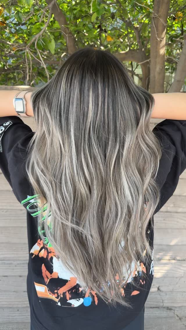Long wavy dark hair with superfine silver-blonde streaks