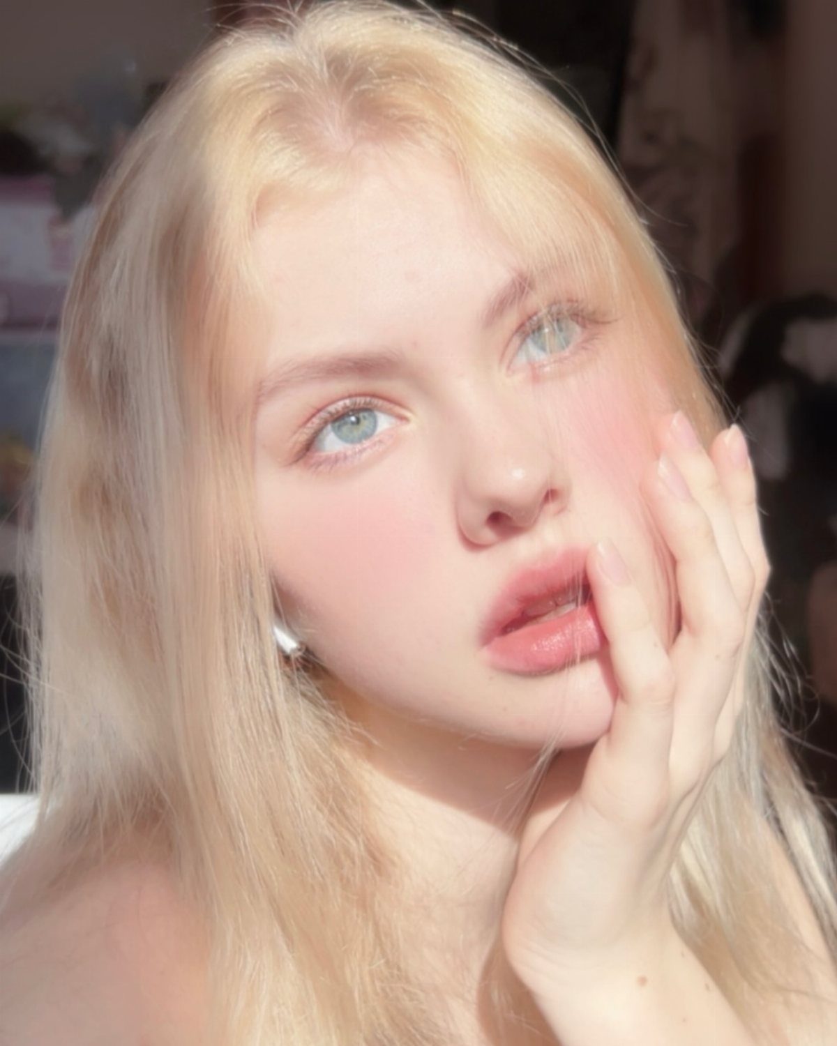 Woman with porcelain skin and long, cool-toned wheat blonde hair
