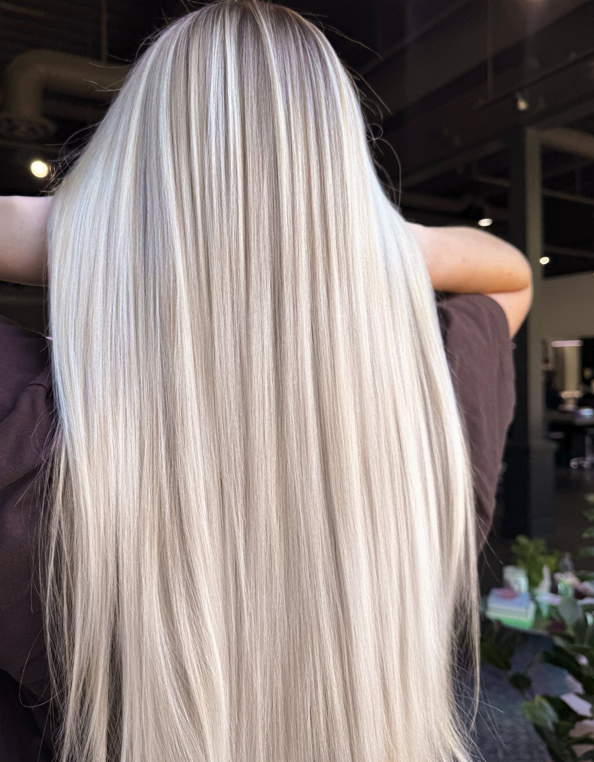 Long silver-blonde hair with cool metallic tones and darker roots