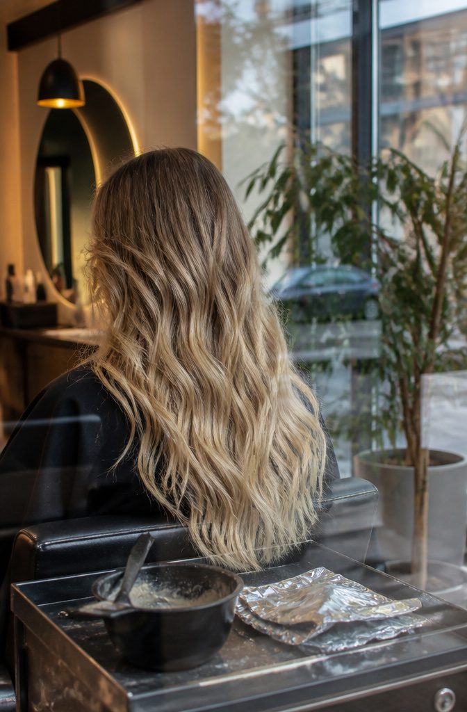 Brown hair with blonde balayage ribbons through the mid-lengths and ends
