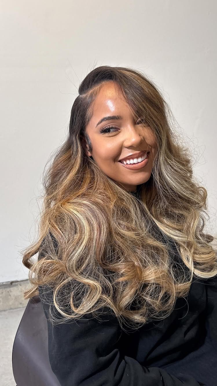 Long wavy brown hair gradually lightening to blonde at the ends