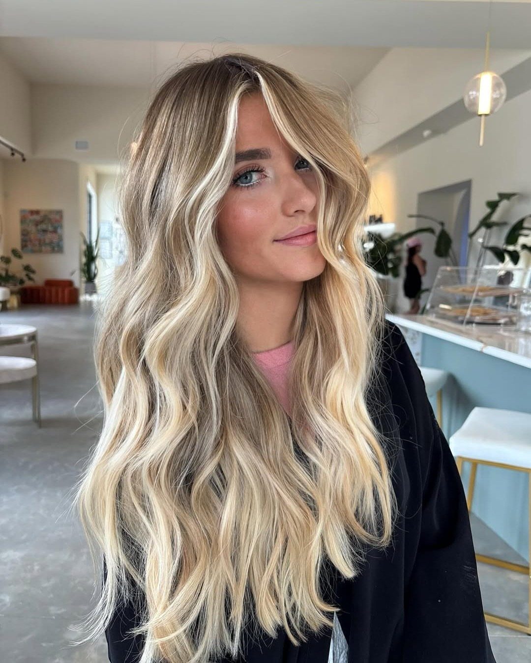 Long wavy brown and blonde hair with bright sandy face-framing accents