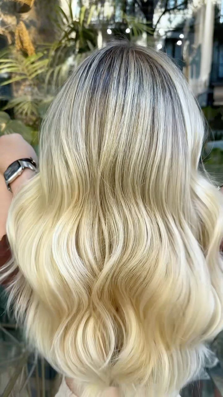 Wavy brown hair blending into pearly champagne blonde balayage