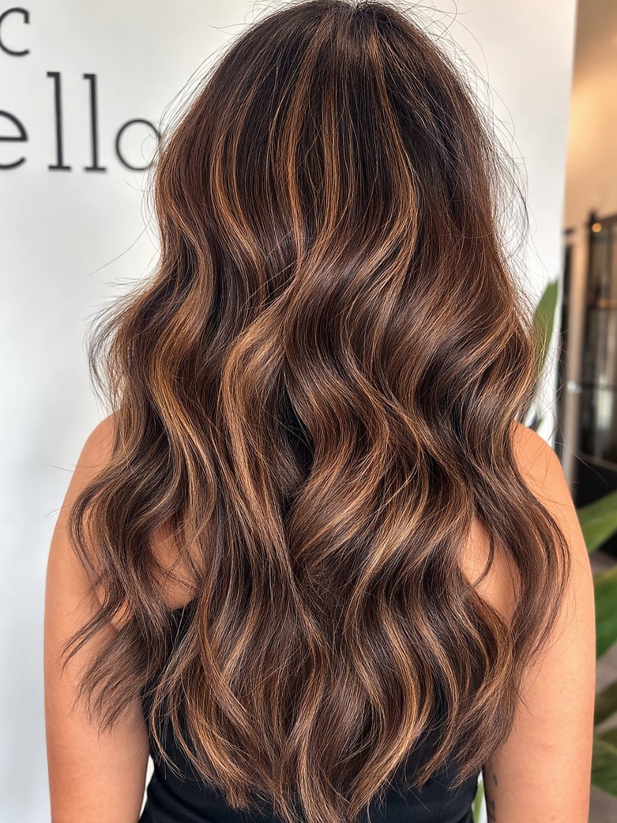 Long wavy red-brown hair with bright caramel highlights and lighter streaks