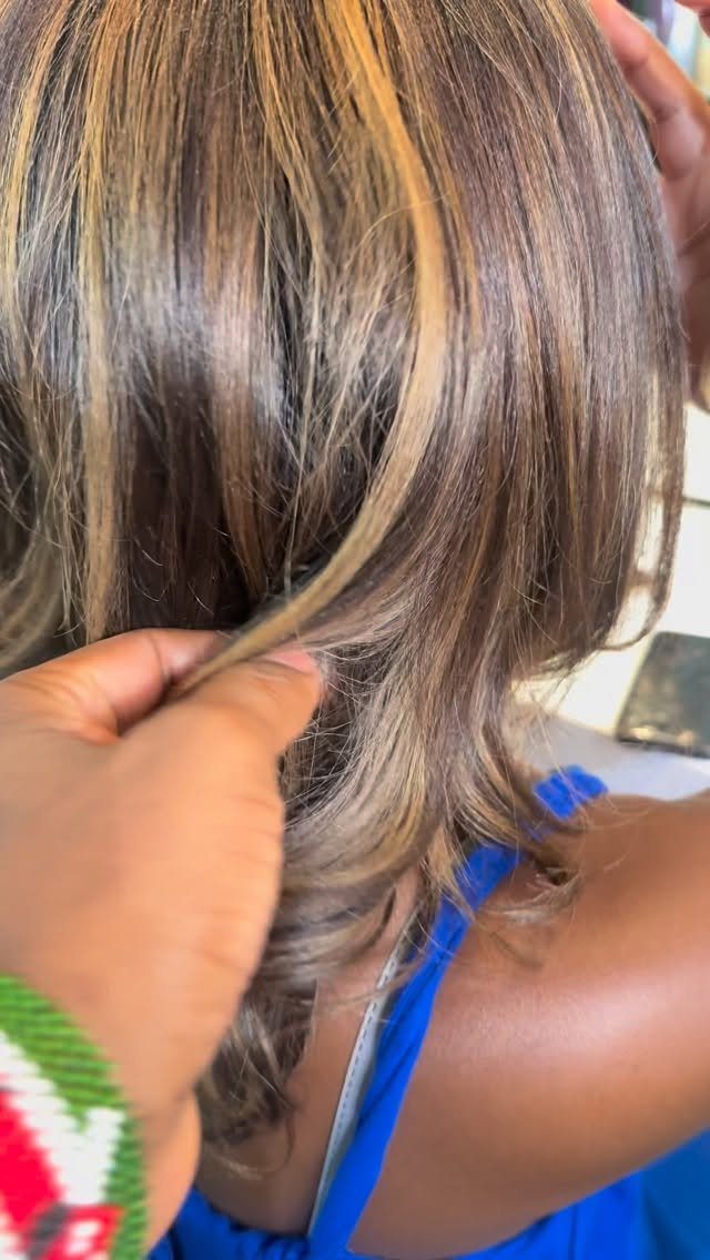 Layered brown hair with caramel streaks and pale face-framing highlights