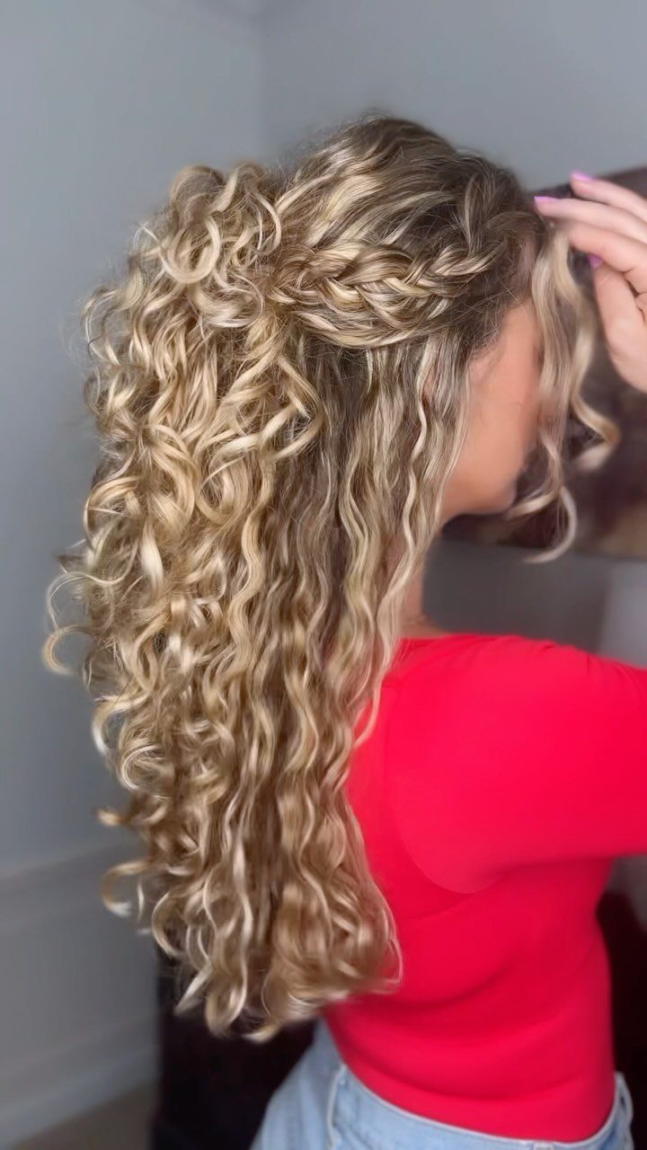 Long blonde curls with a small braid swept halfway back