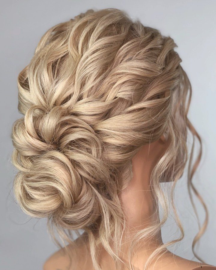 Blonde hair styled in a voluminous twisted updo with a loose curled bun