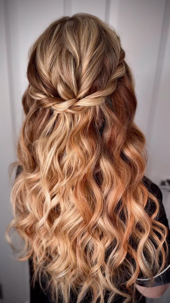 Wavy caramel blonde hair styled in a braided half-up twist