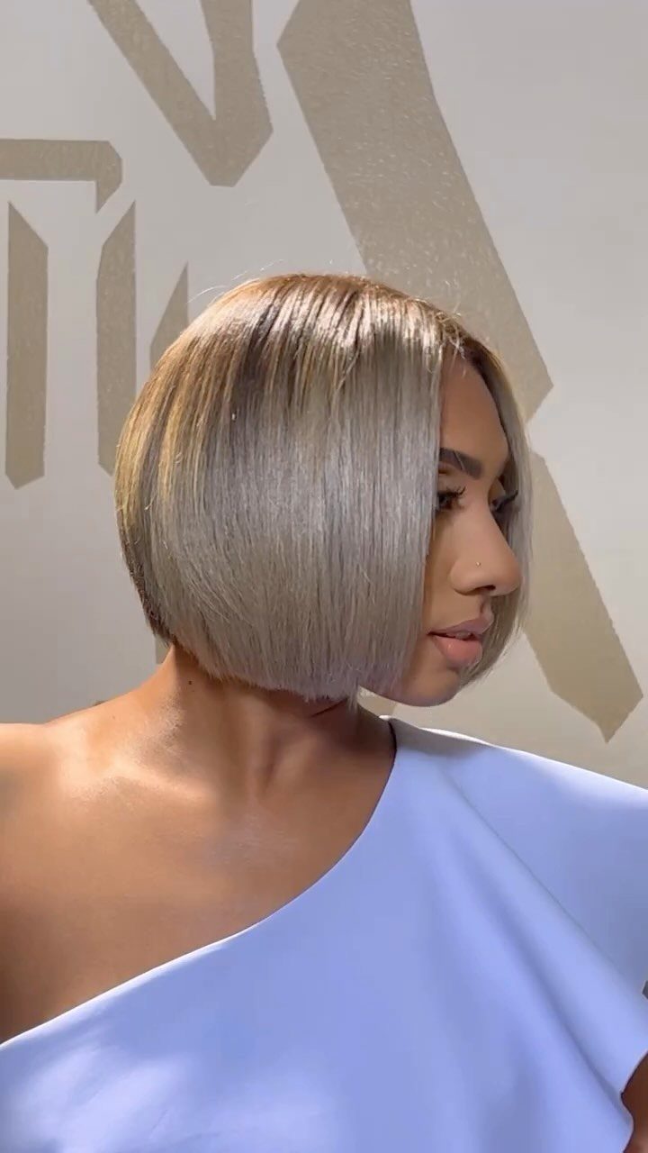 Woman with a sleek chin-length blonde bob and cool beige highlights