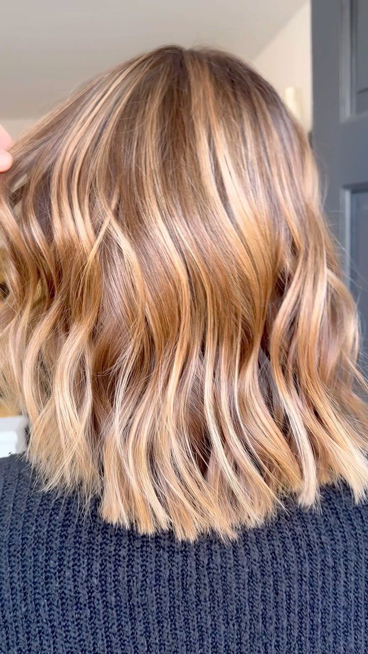 Wavy dimensional strawberry blonde hair with copper and light blonde strands