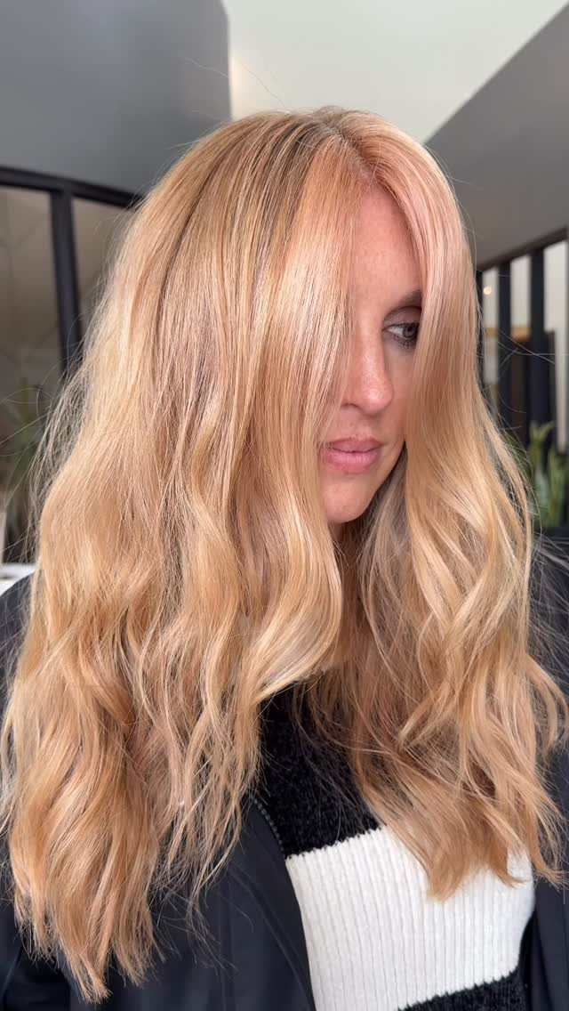 Long wavy golden copper blonde hair with subtle warm highlights