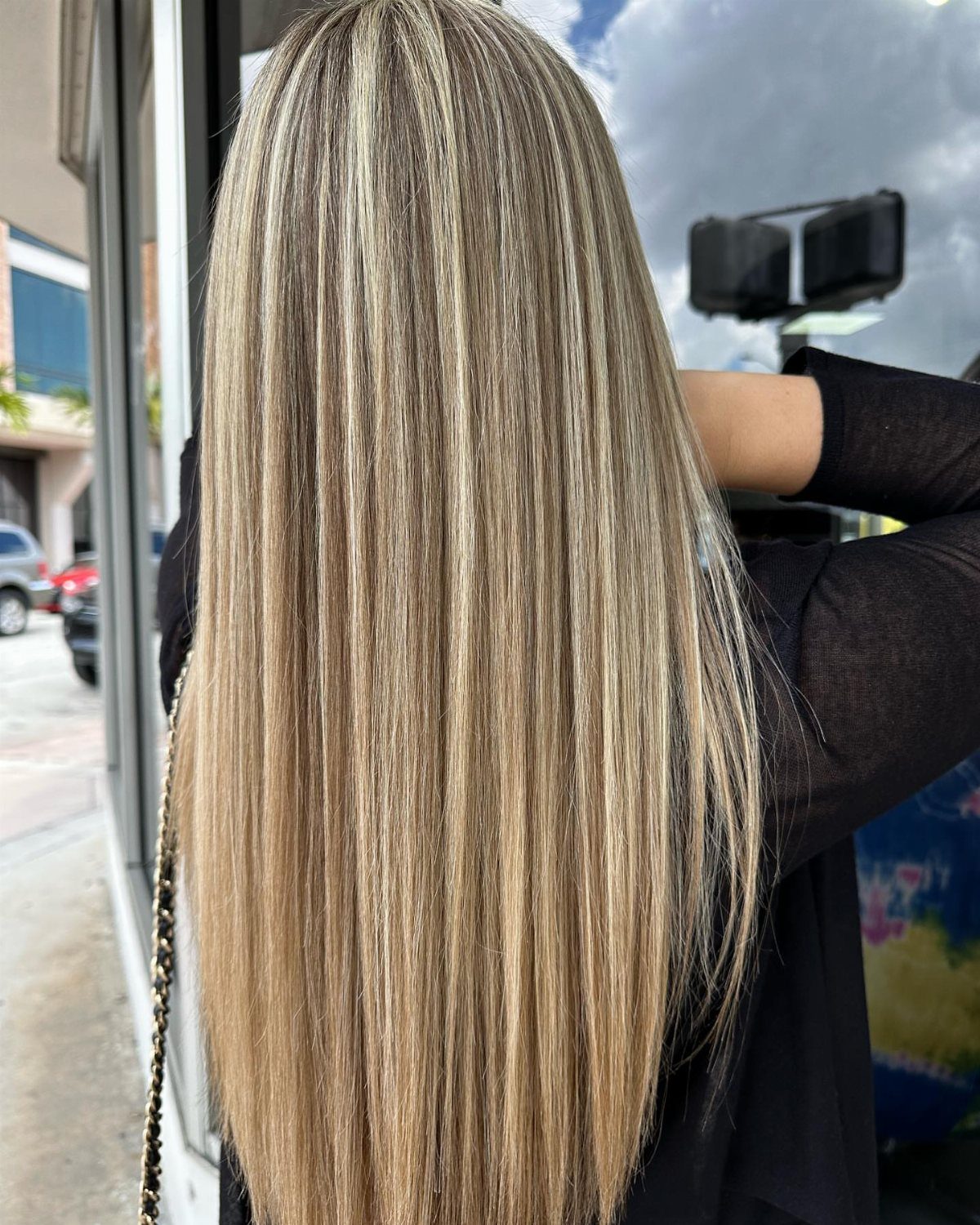 Long sandy blonde hair with fine, subtle highlights viewed from behind