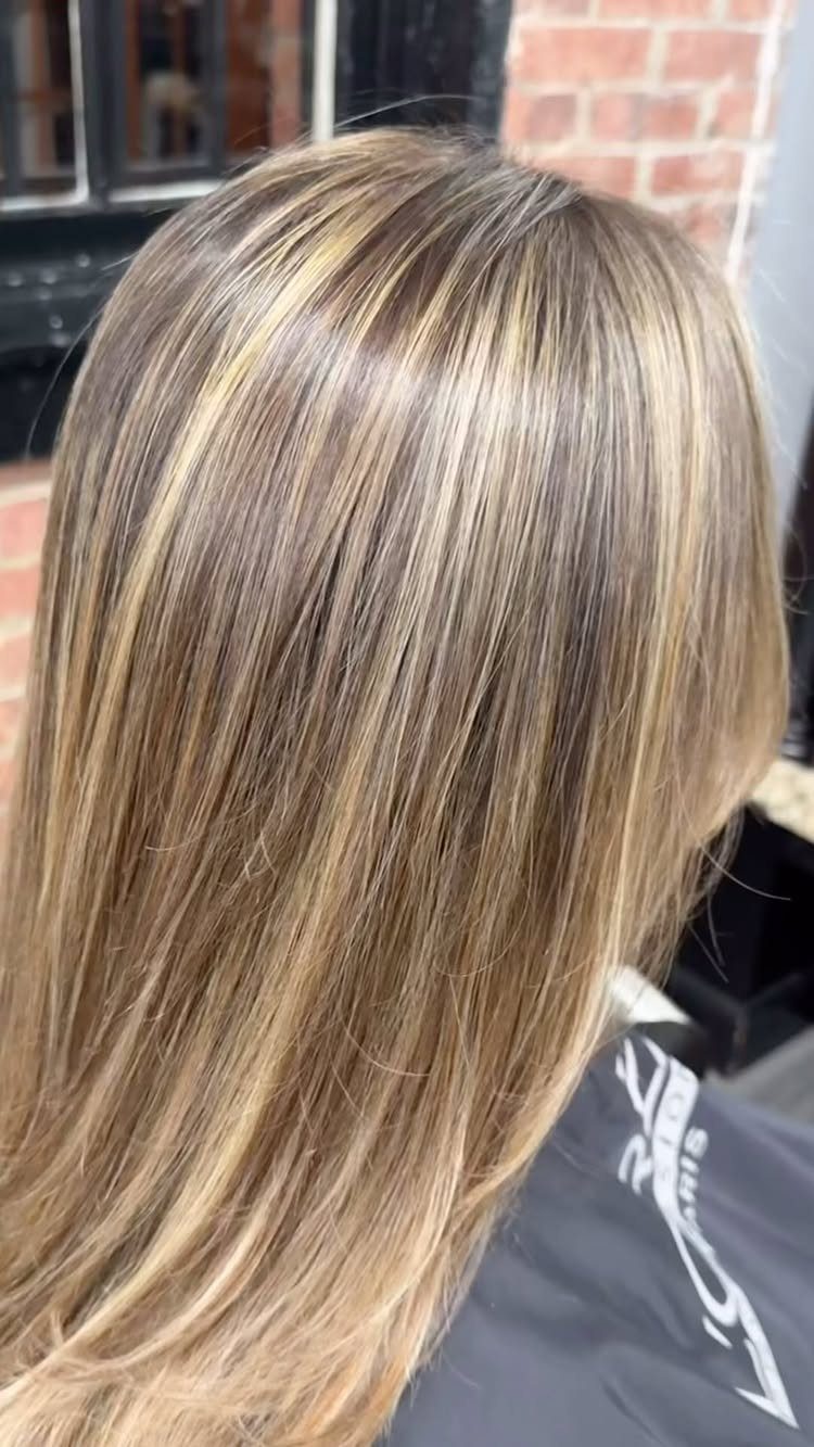 Long light brown hair brightened with fine honey-blonde highlights