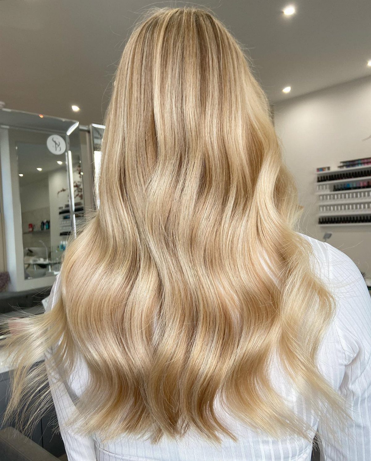 Long golden blonde waves show a warm, classic honey blonde shade.