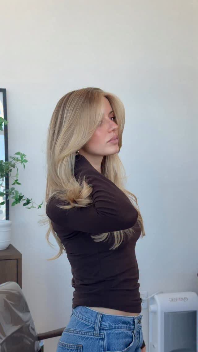 Long honey blonde hair with brighter face-framing strands and softly curled ends