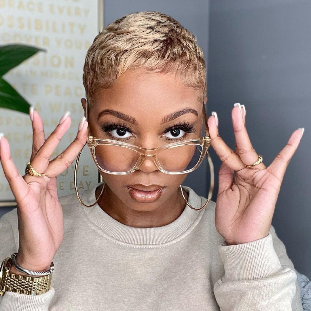 Short honey-blonde pixie haircut styled close to the head