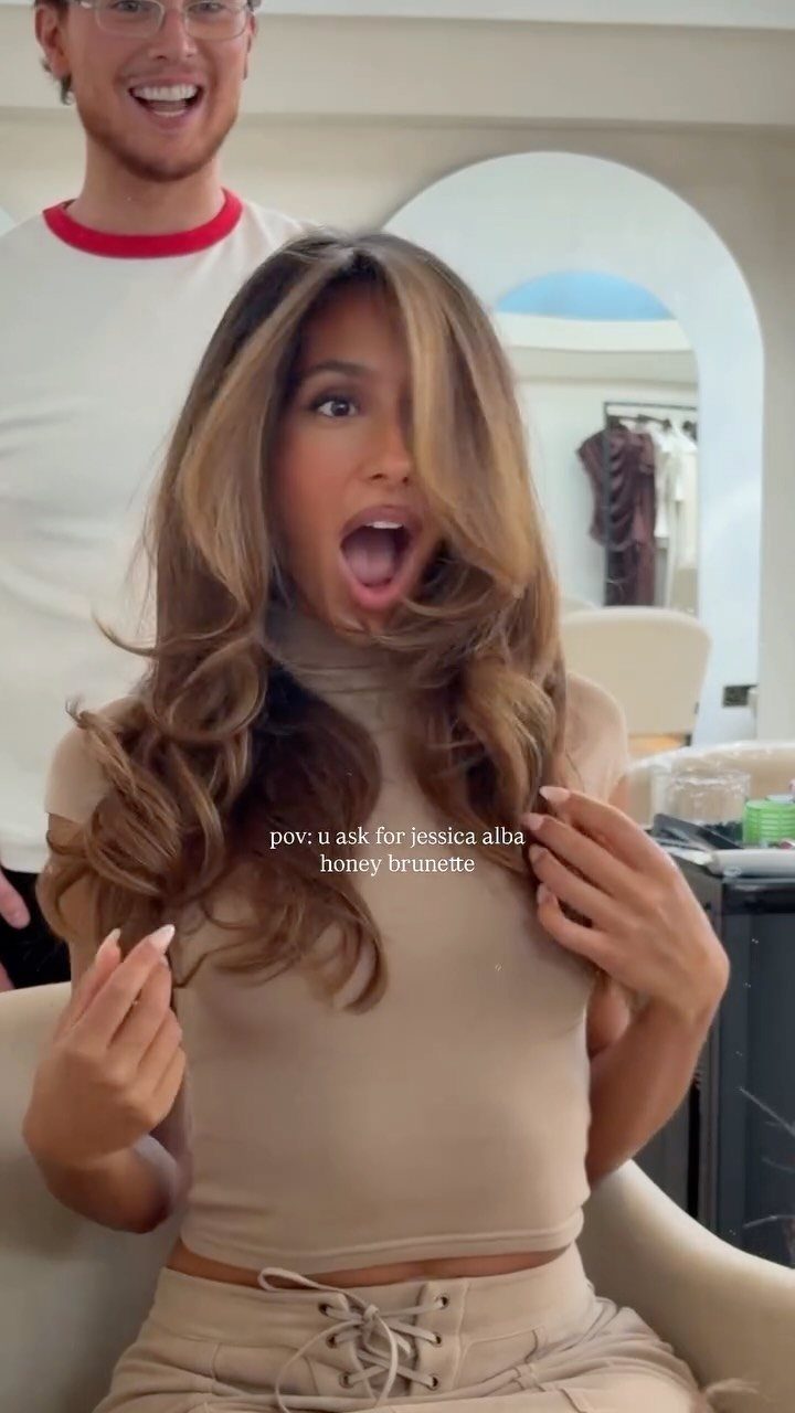 Woman displays blended brown and blonde hair with bright face-framing strands