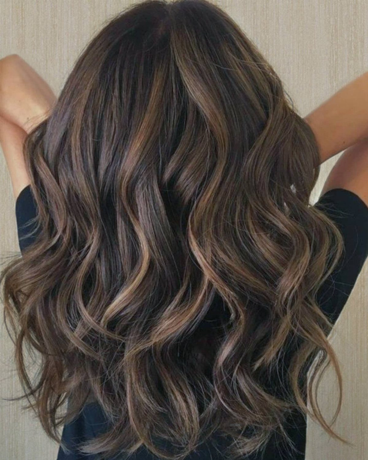 Long dark brown waves with subtle honey-toned lowlights