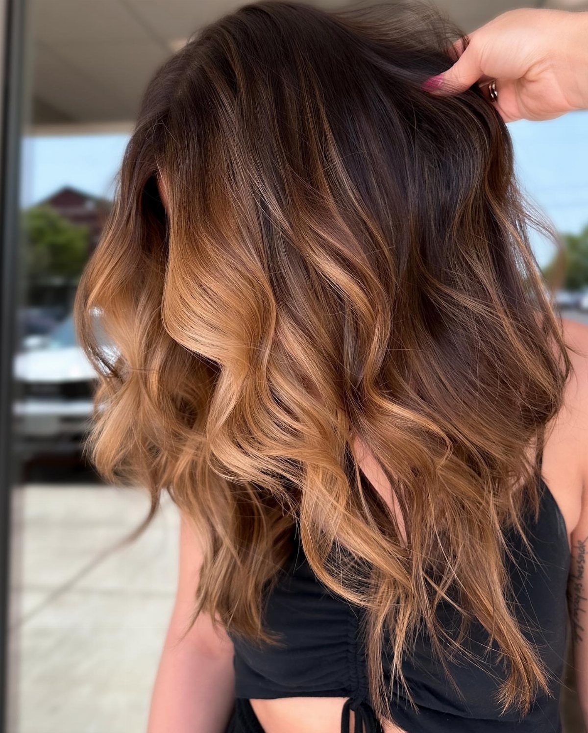 Wavy brown hair with honey highlights and darker roots
