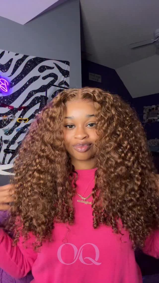 Person wearing long medium honey brown curls with warm golden tones