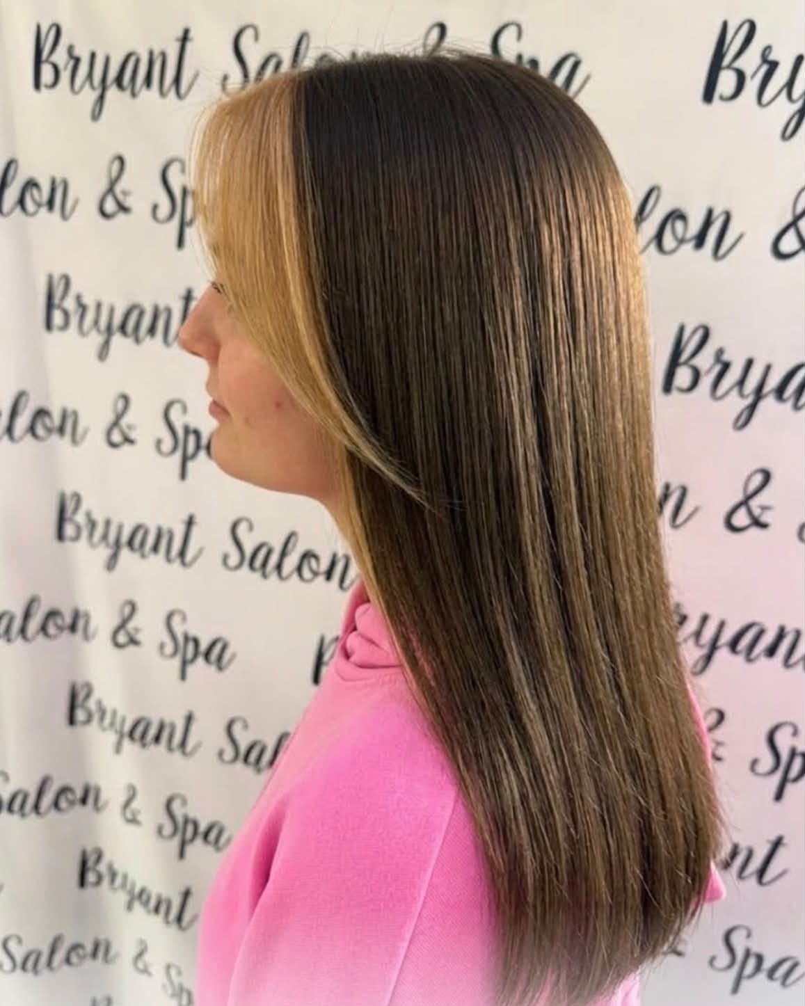 Long brown hair with a pale blonde money piece framing the face