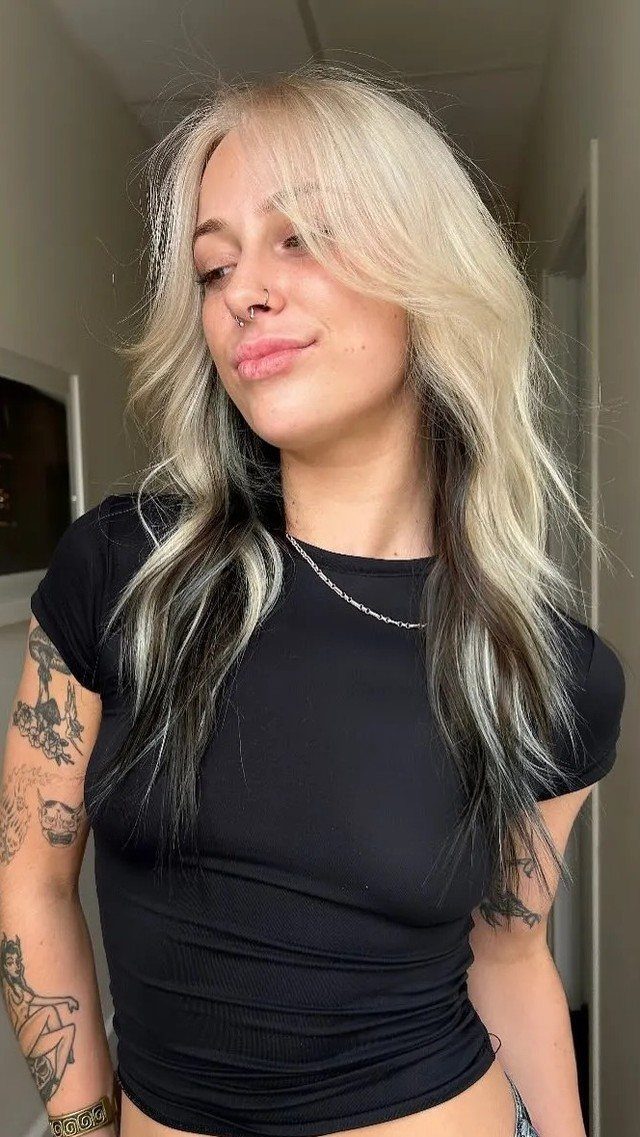 Woman showing two-toned hair with blonde top sections and dark brown lengths
