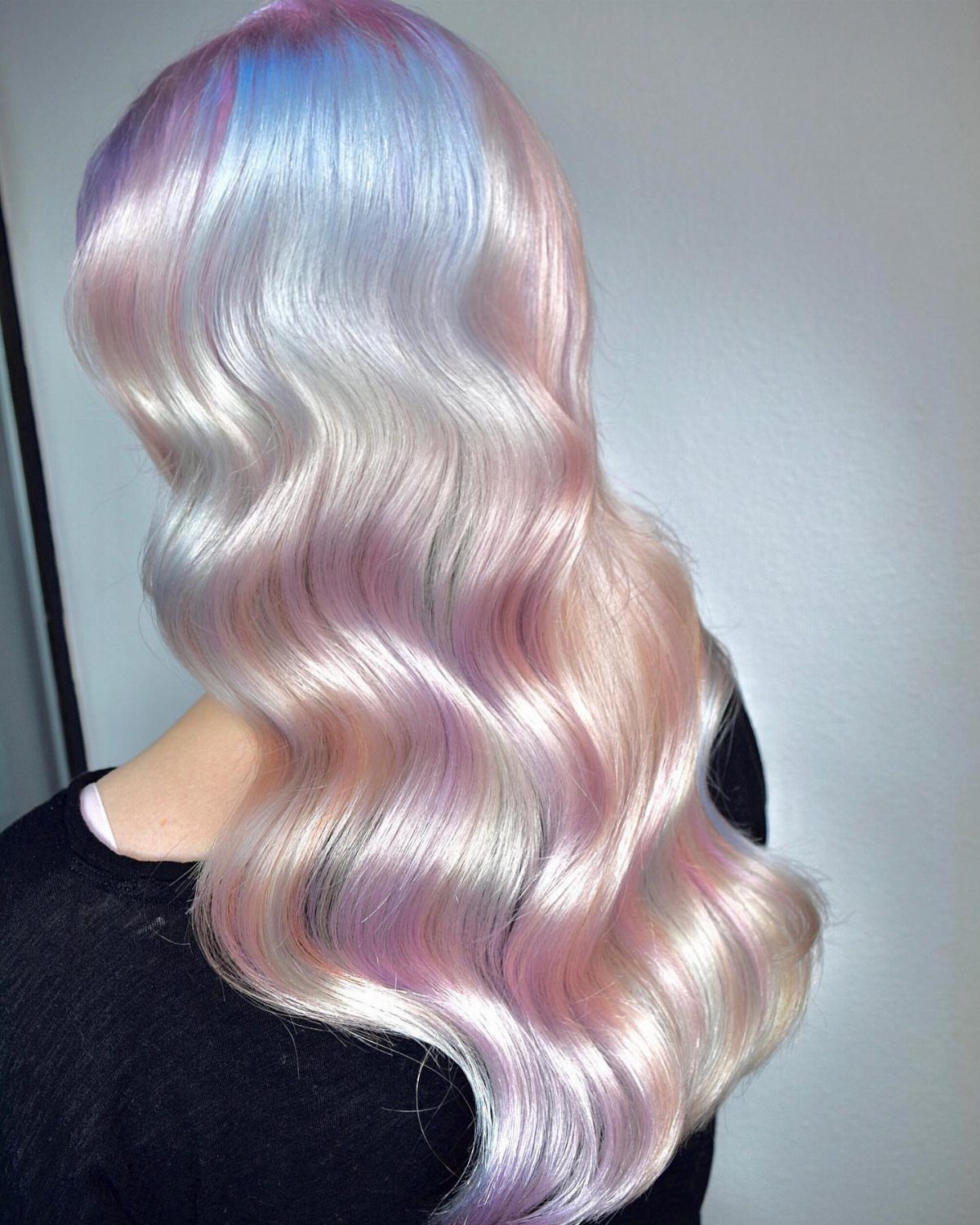 Long icy blonde waves blend with lavender and pale pink tones