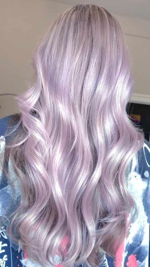 Long wavy pale pink blonde hair with a soft lilac sheen