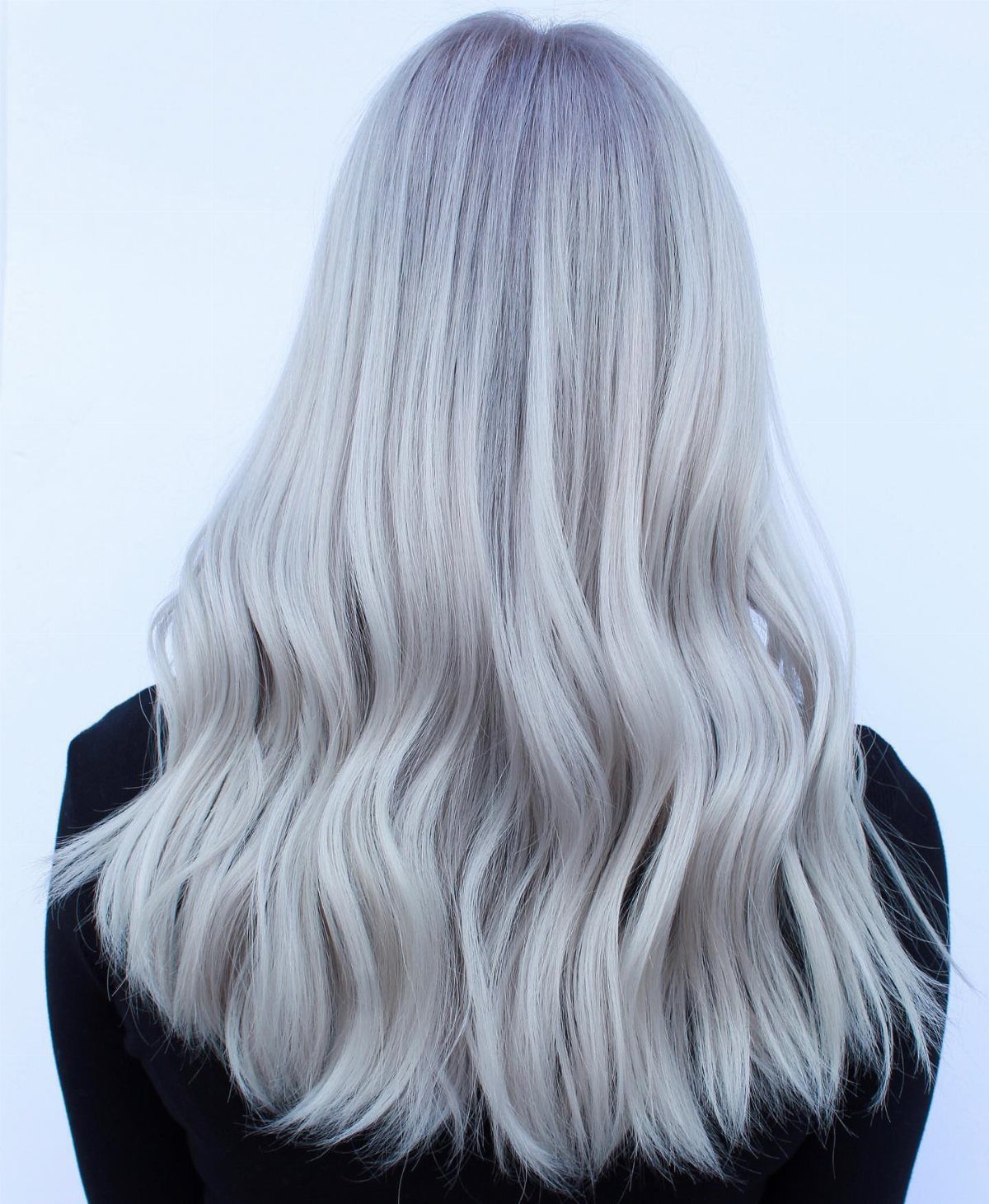 Long wavy pale silver-blonde hair with cool lavender tones and darker roots