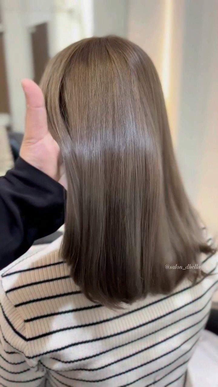 Straight, glossy shoulder-length light brown hair shown from behind