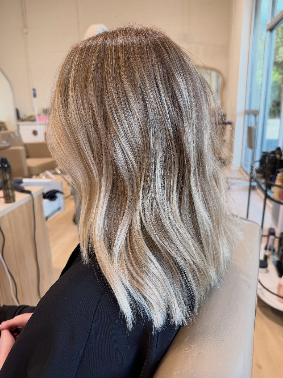 Shoulder-length cool blonde hair with dark roots and blended highlights