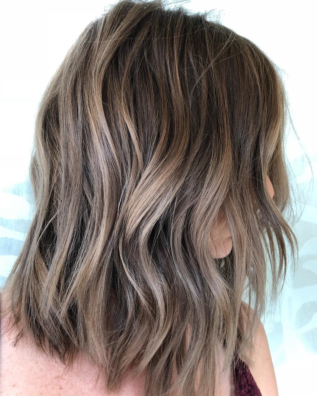 Wavy dark blonde hair with dimensional brown and bronze highlights