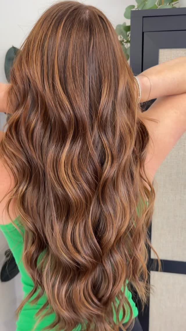 Long wavy dark strawberry blonde hair with warm copper tones