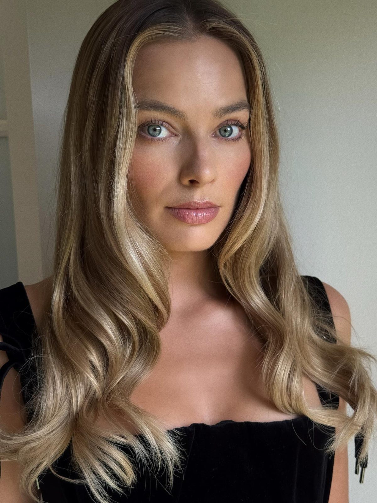 Woman with dimensional blonde waves and brighter face-framing strands