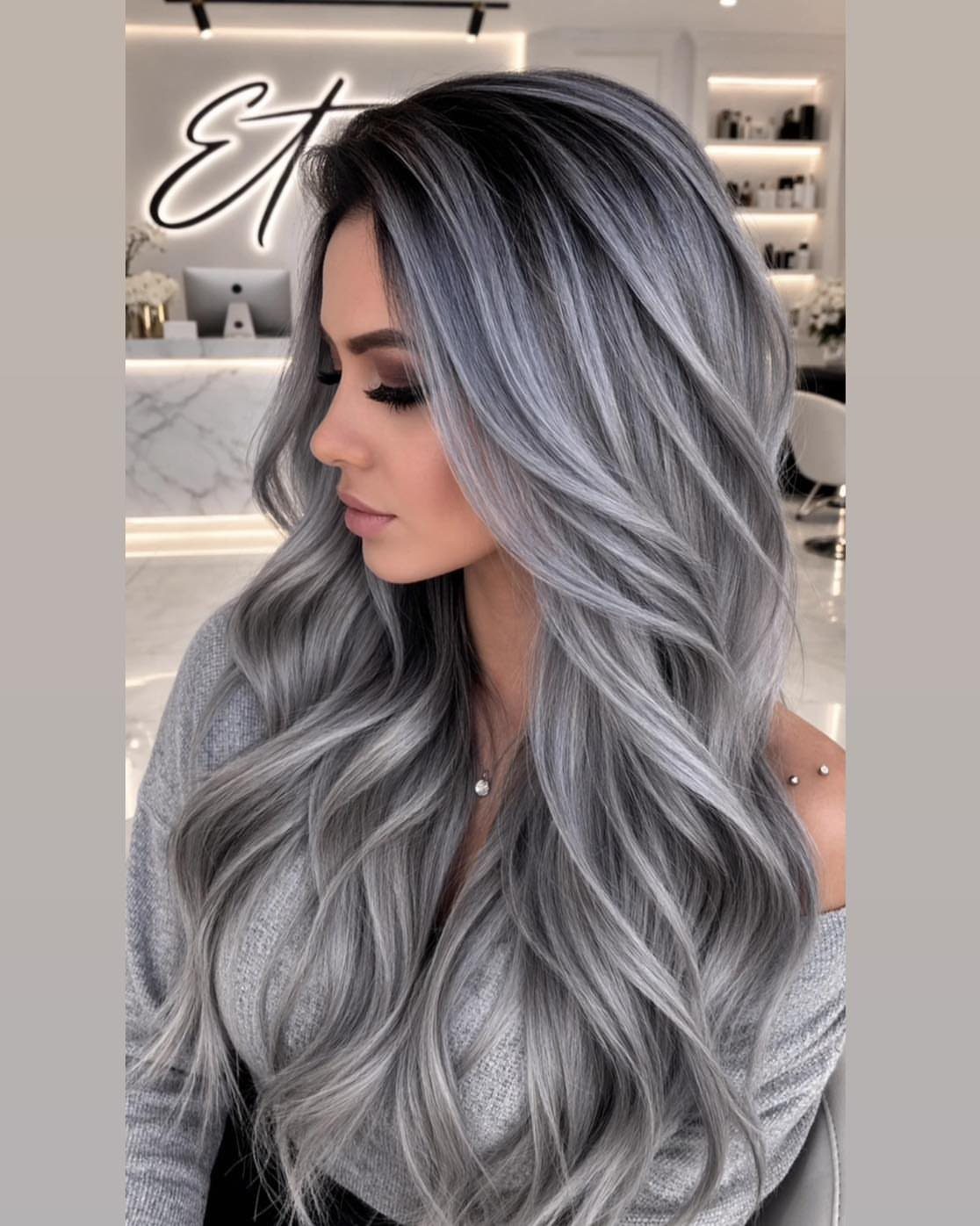 Woman with long, wavy iced platinum ash hair and feathered layers