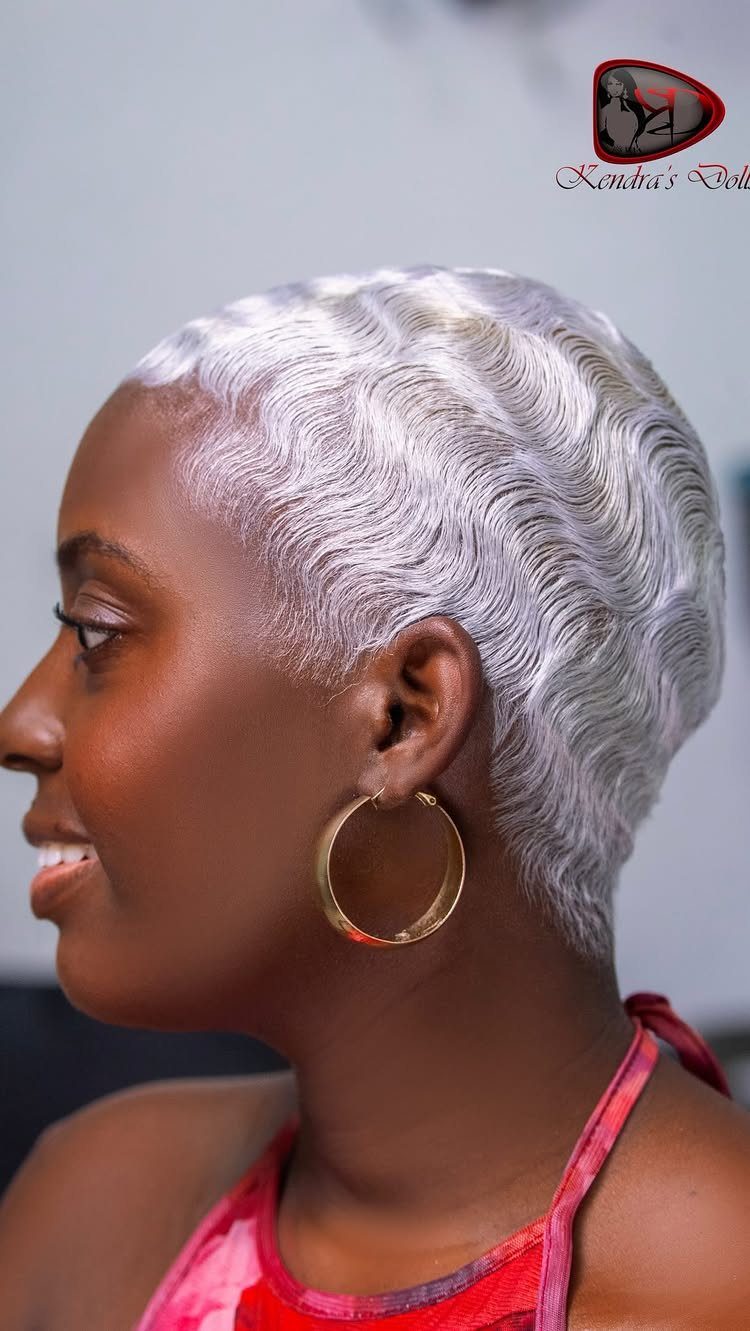 Woman showcasing short platinum blonde hair styled in sculpted rippling waves
