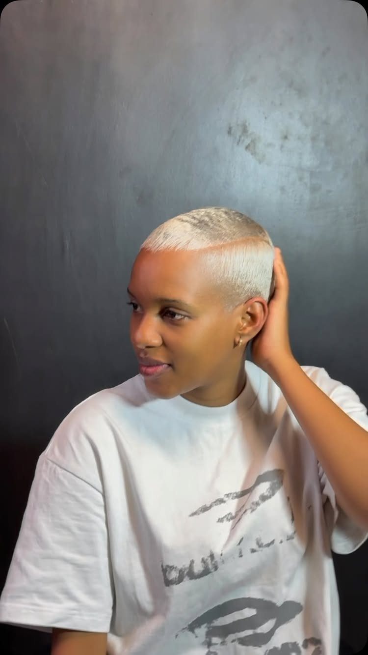 Person displaying close-cropped silver-platinum hair with darker roots