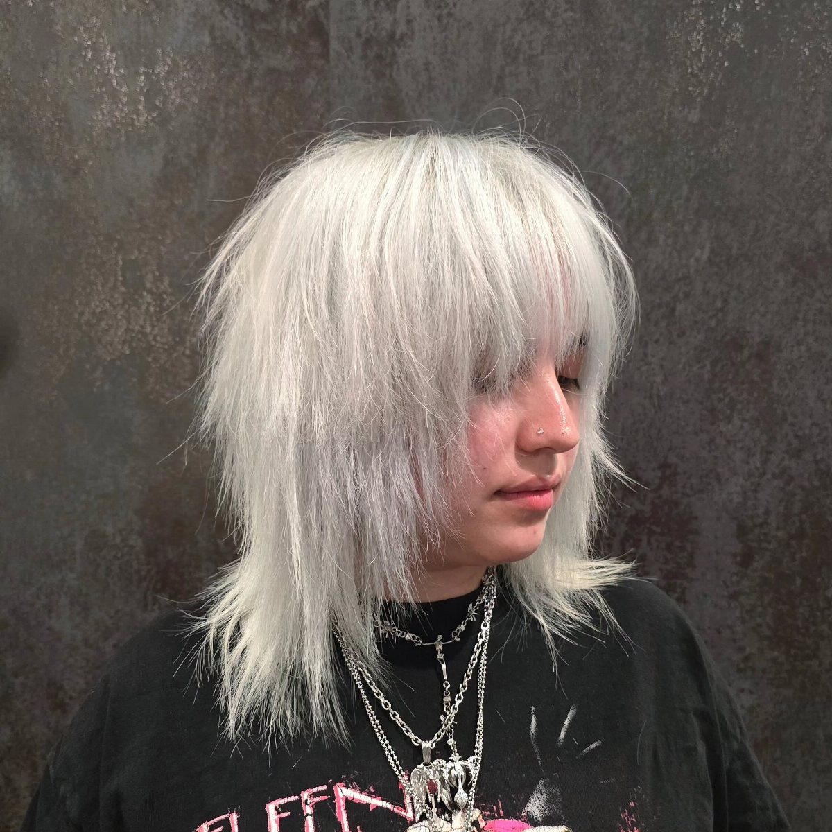 White-platinum shag haircut with choppy layers and long bangs