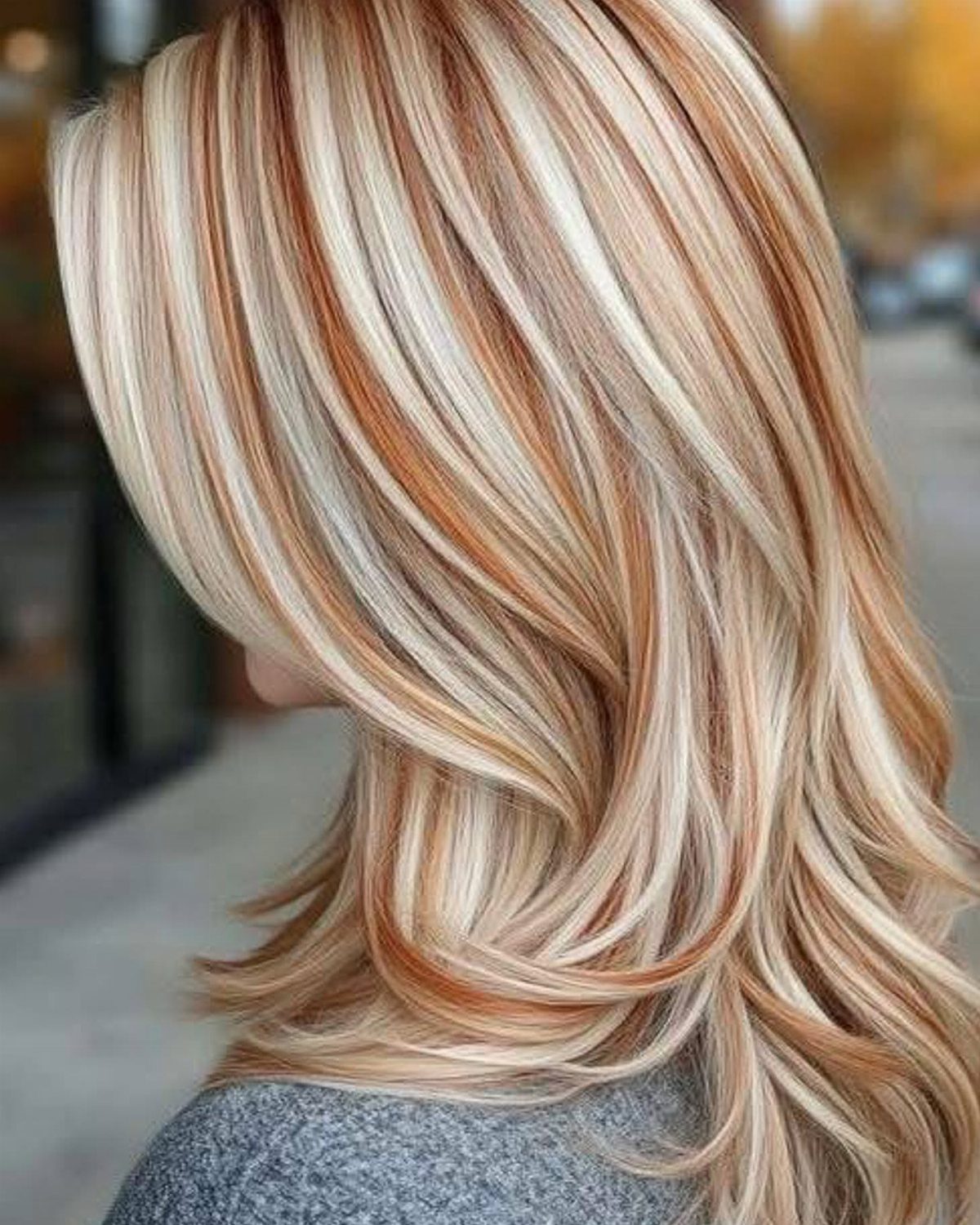 Long layered hair showing sandy blonde highlights and darker dimensional strands