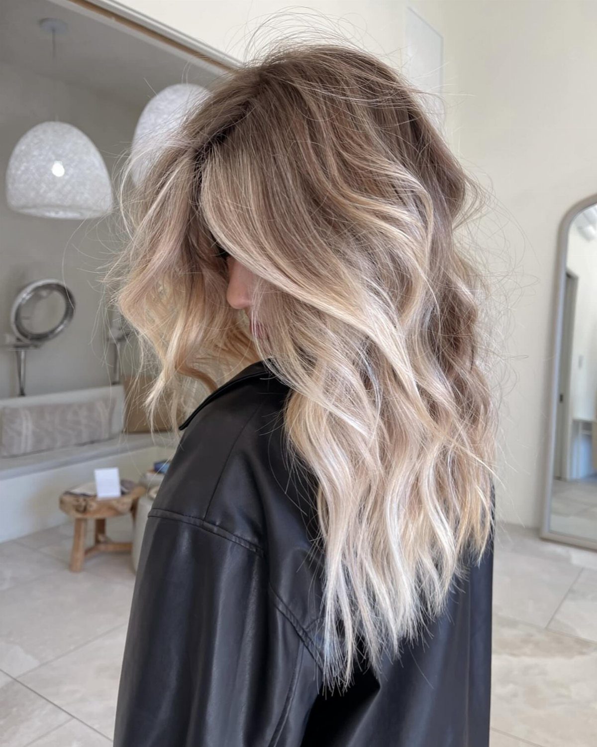 Long wavy sandy blonde hair with darker lowlights and pale blonde strands