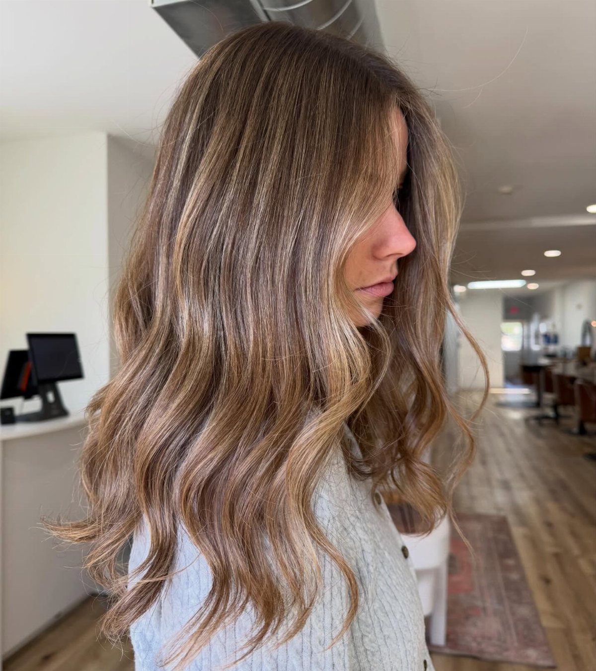Wavy sandy blonde bronde hair blends brown depth with lighter highlights