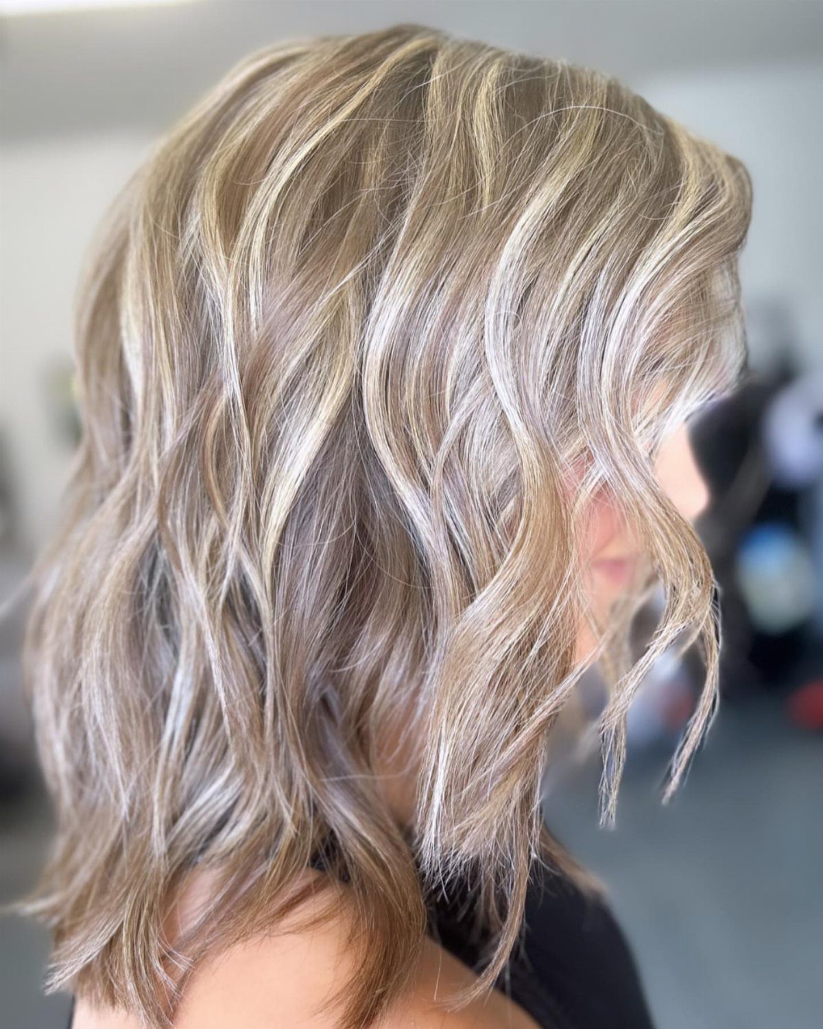 Wavy sandy blonde hair with darker strands adding depth throughout